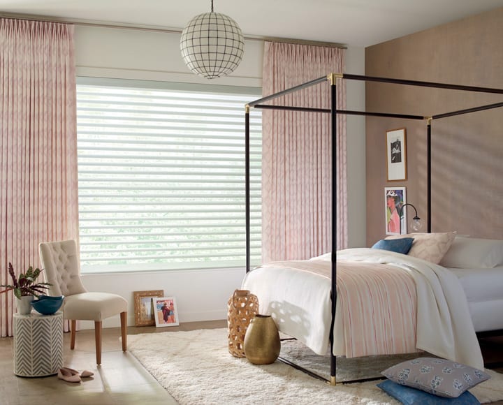 girls bedroom with pink floor to ceiling full drapery window treatments with sheer shades covering window