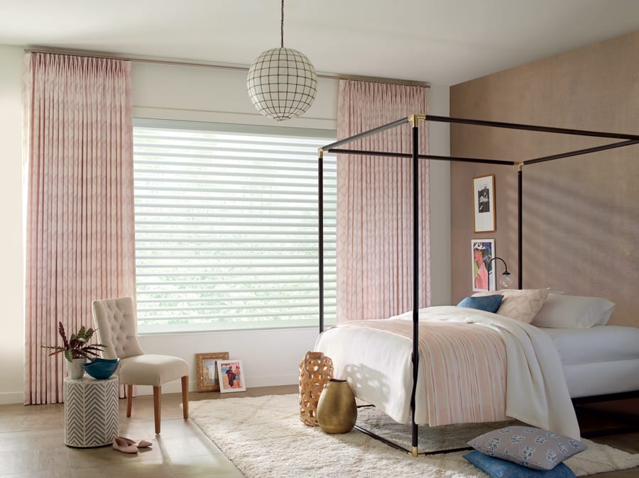 Bedroom in Houston home with layered look from Design Studio window treatments