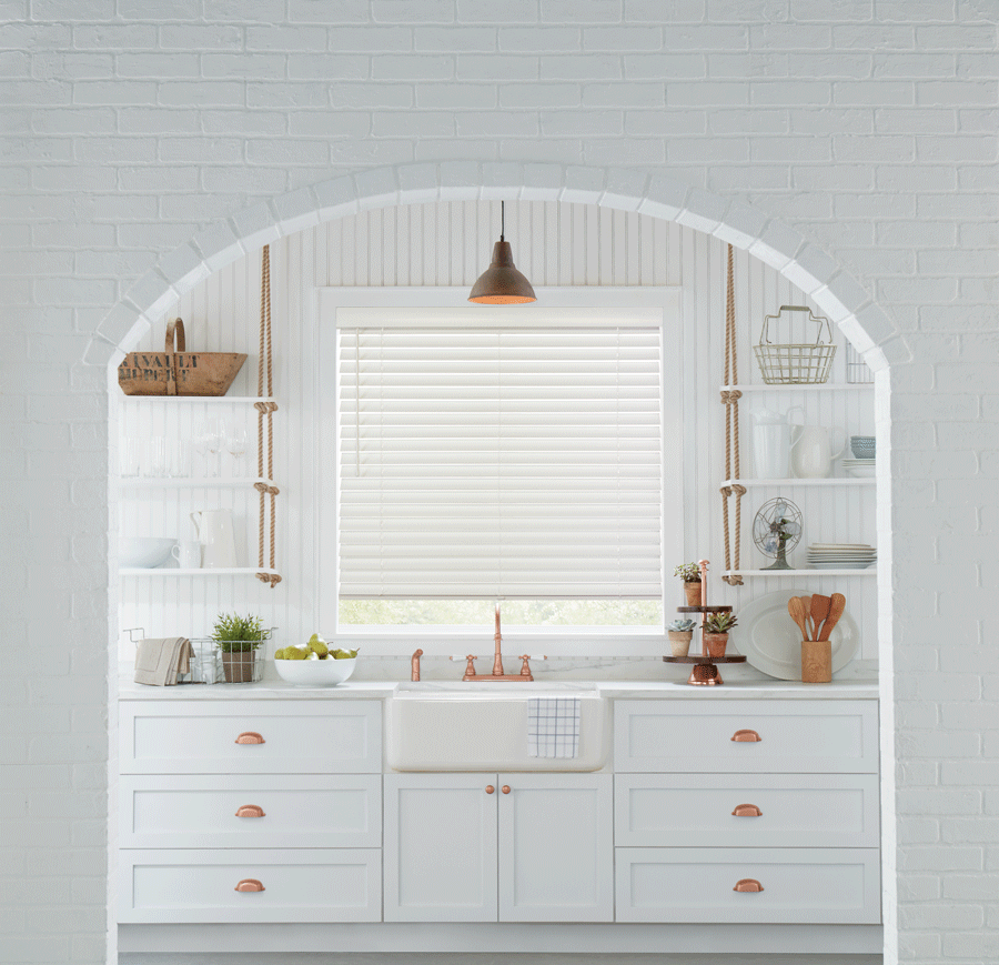 accents of gold hardware in white kitchen with white window blinds Houston TX