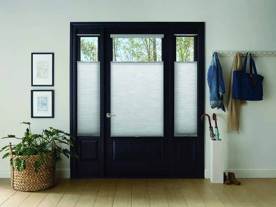 Glass front door features top-down window shades for home protection