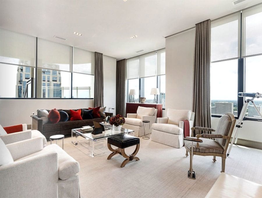 houston living room with floor to ceiling windows draperies and shades 