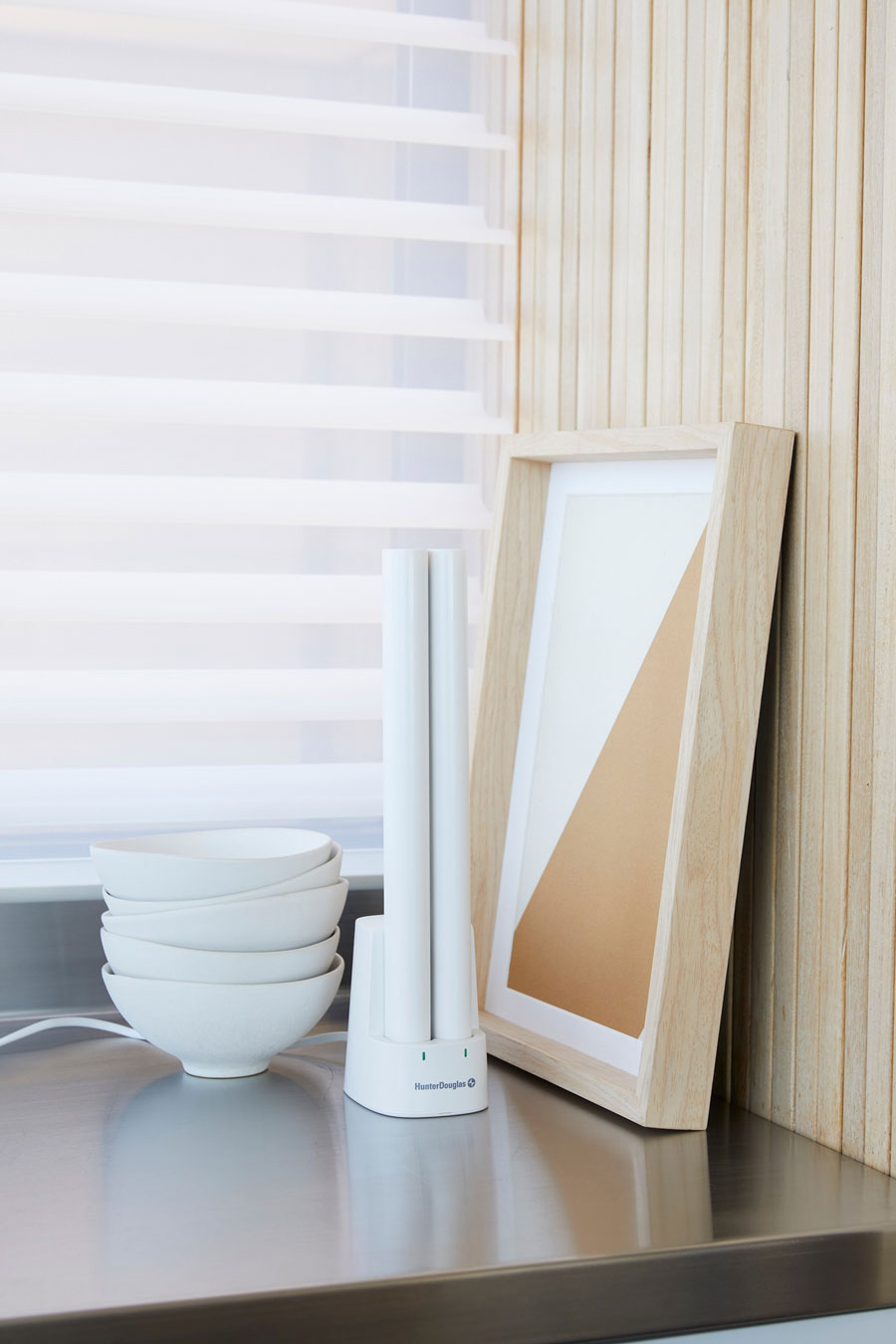 Rechargeable battery wands for motorized shades placed in charging docks