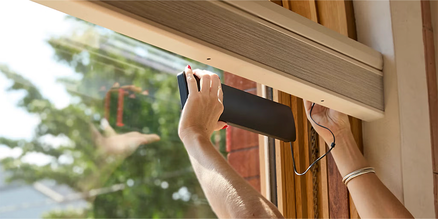 solar charger for rechargeable batteries of motorized shades being attached inside the window