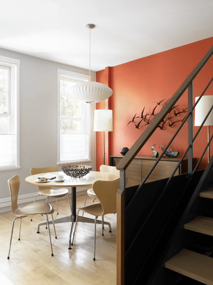 rust accent wall in contemporary dining room 