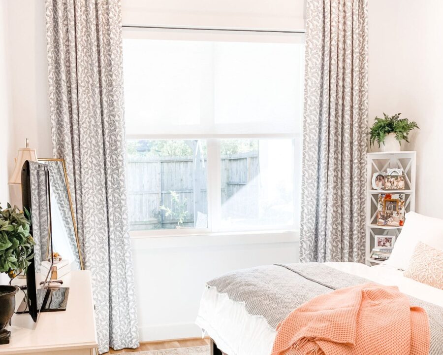 patterned gray draperies with white roller shades in Houston TX