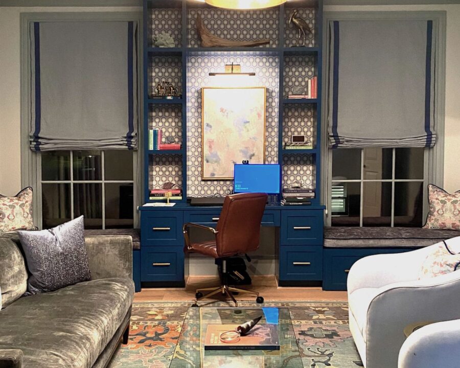 living room with large office built-in desk and windows with gray fabric shades in Magnolia TX
