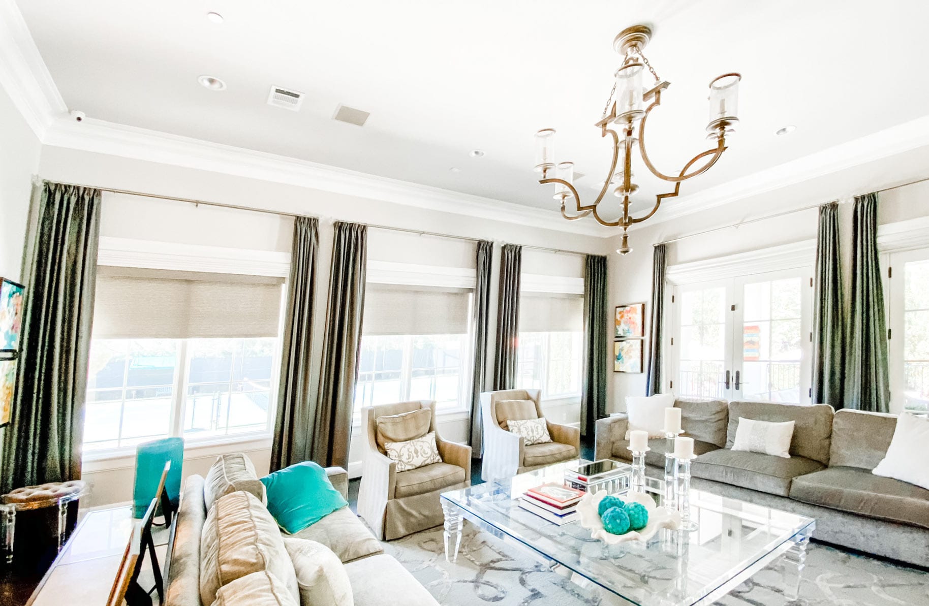 beige roller shades with olive green drapery in Houston living room