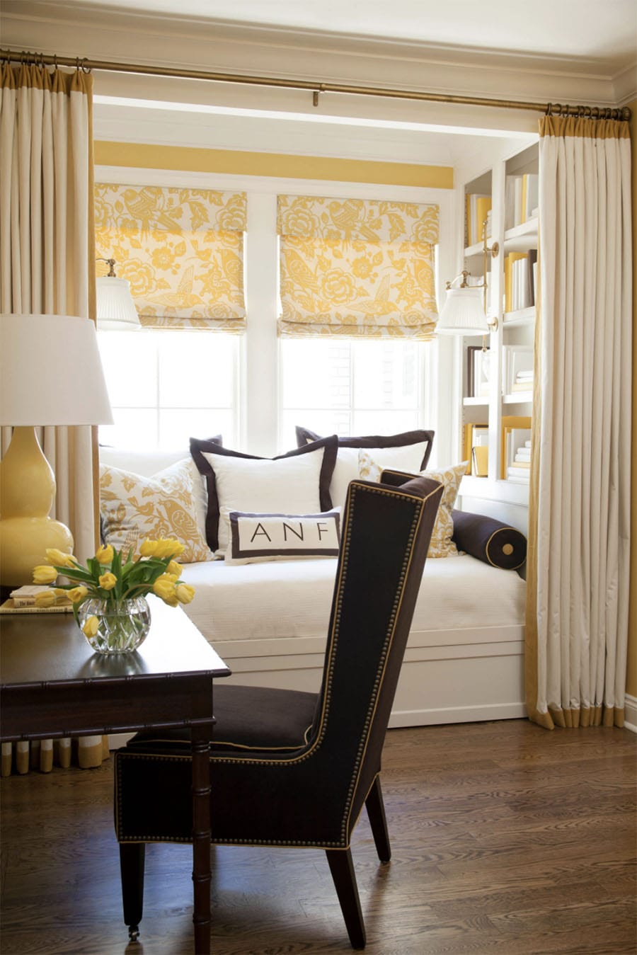 dining room bay window nook with yellow roman shades