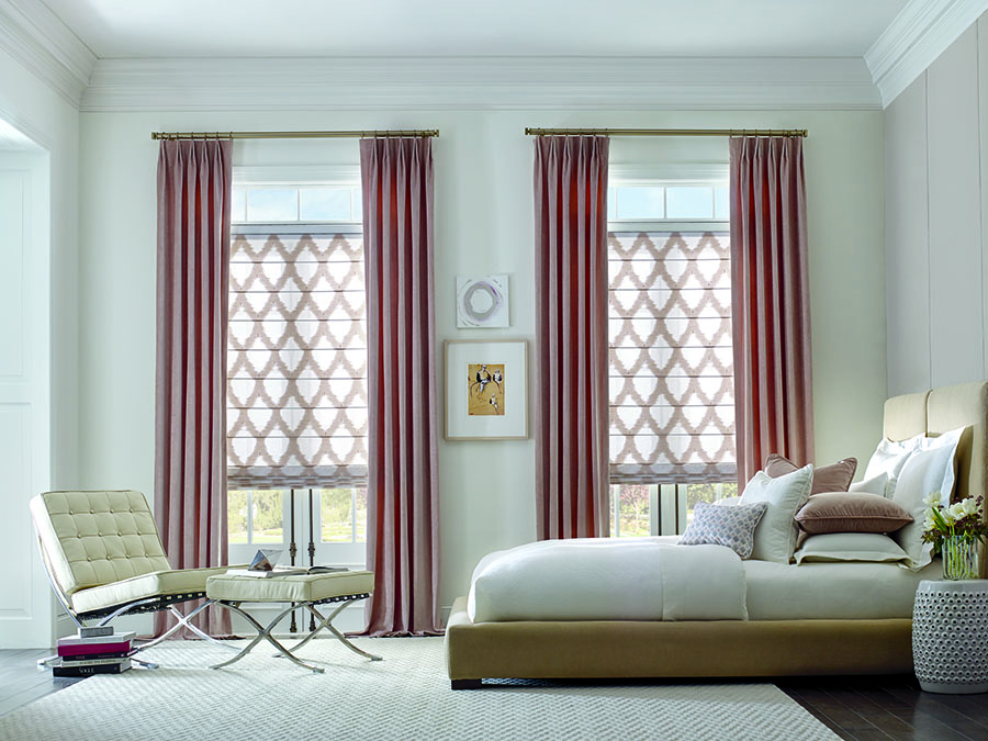 pink draperies with patterned white and pink fabric shades in bedroom in houston TX