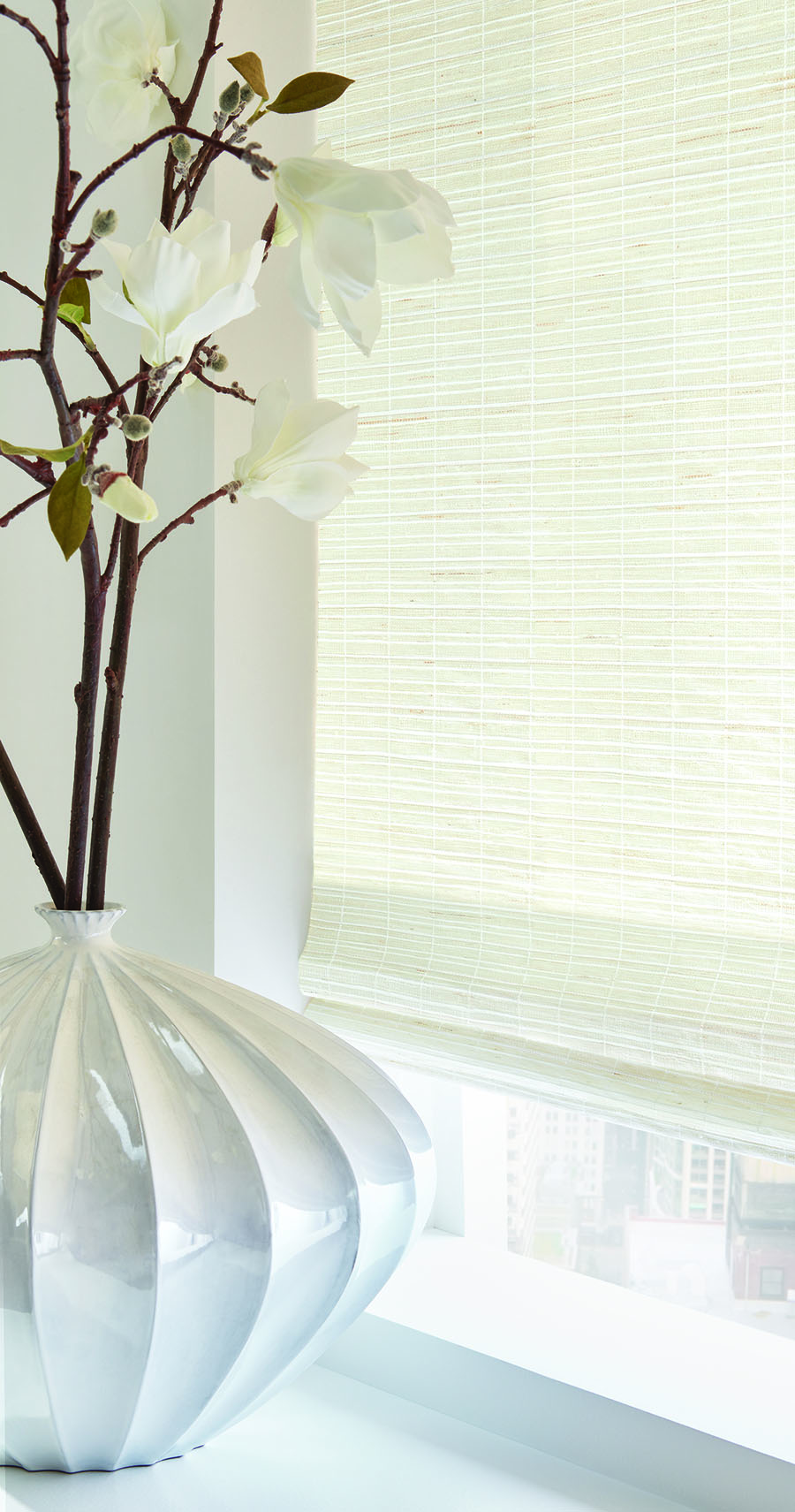 white woven wood shades with white modern vase in houston TX