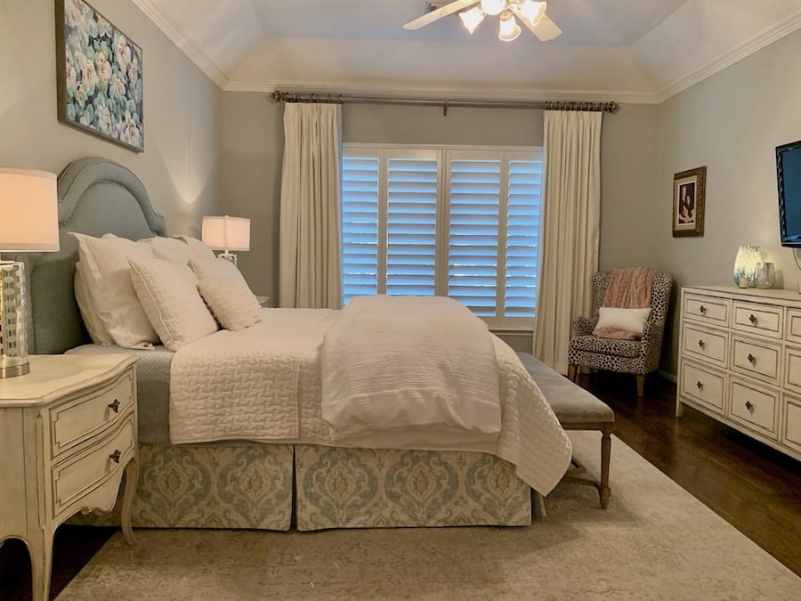 bedroom in Houston with shutters and drapery on windows for relief for houston 