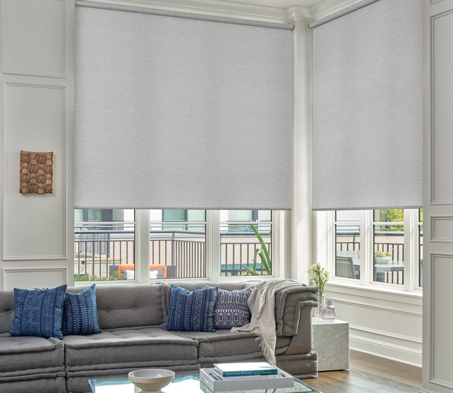 living room with large windows and designer roller shades in Houston area home