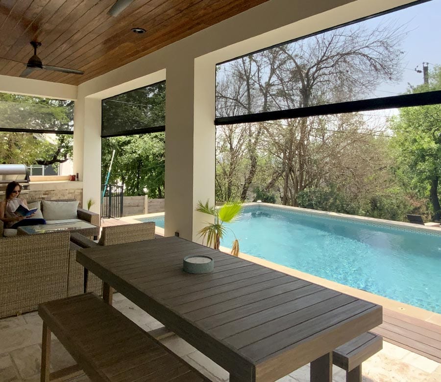 poolside patio with black exterior screen shades to bring the outdoors in for Houston TX home