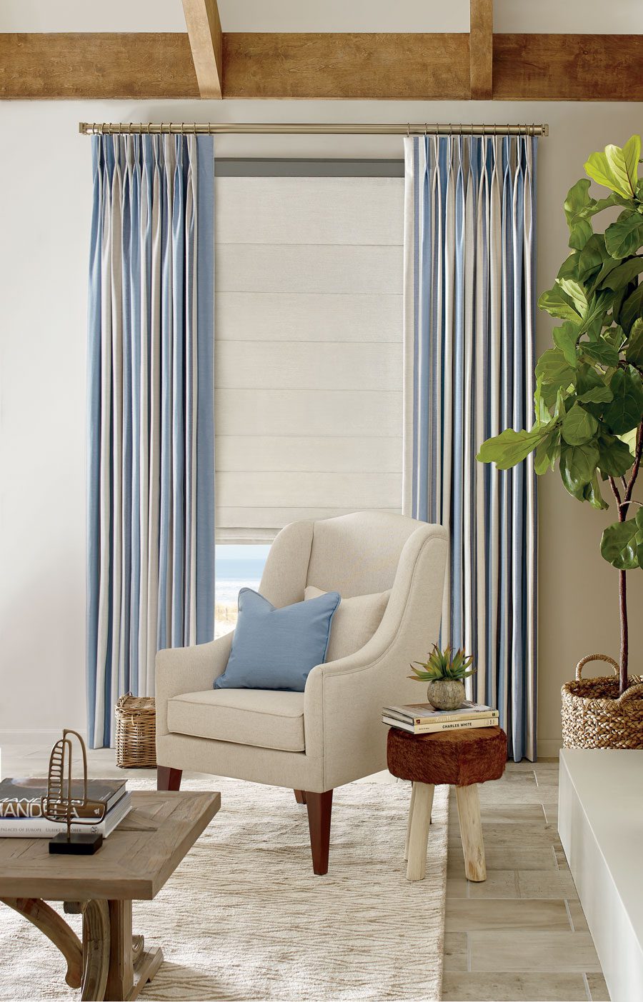 blue striped drapery panels with white fabric roman shades in Houston living room