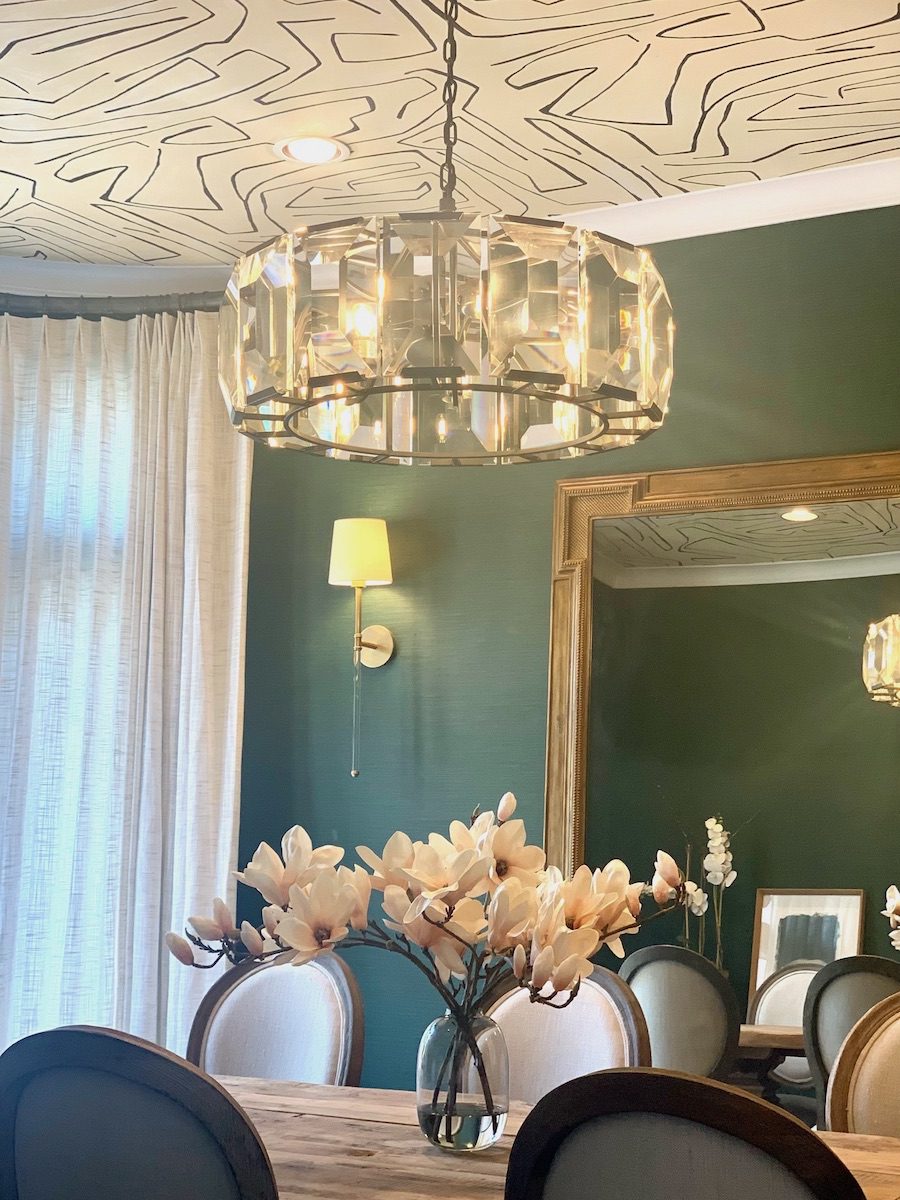 green walls in dining room with ceiling wallpaper in Friendswood TX