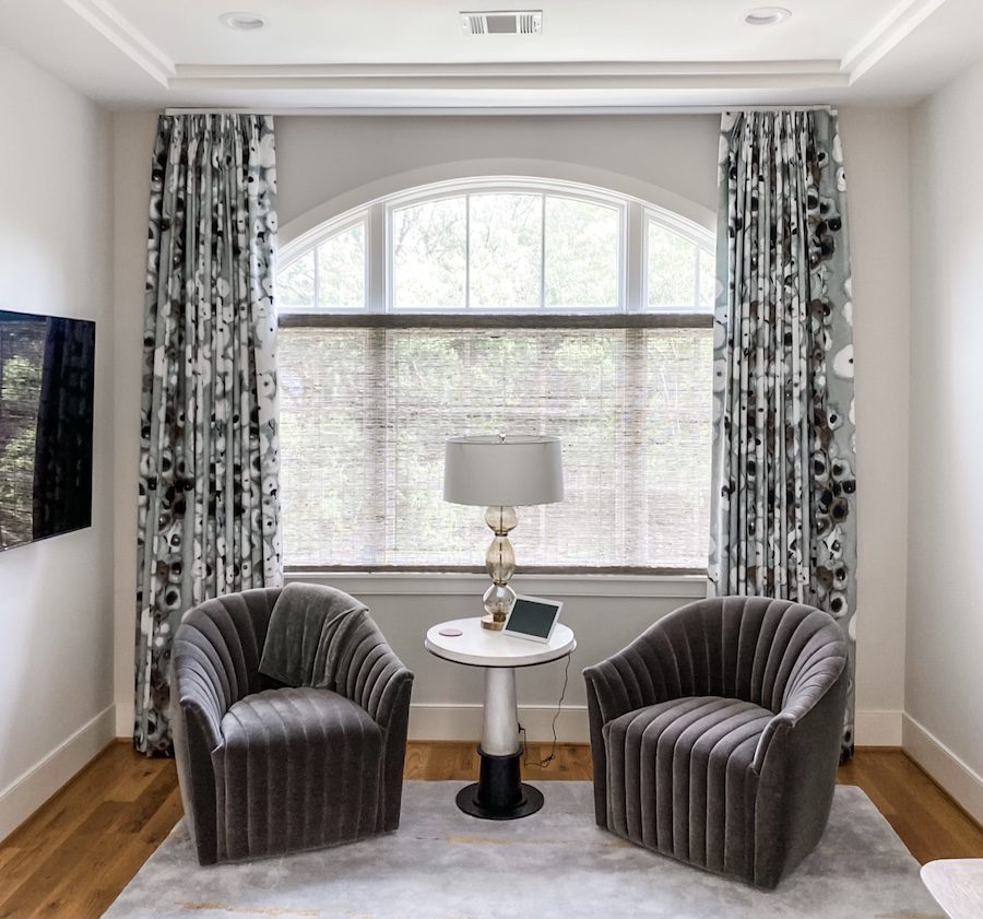 sitting area with gray chairs and floral fabric draperies in Baybrook TX