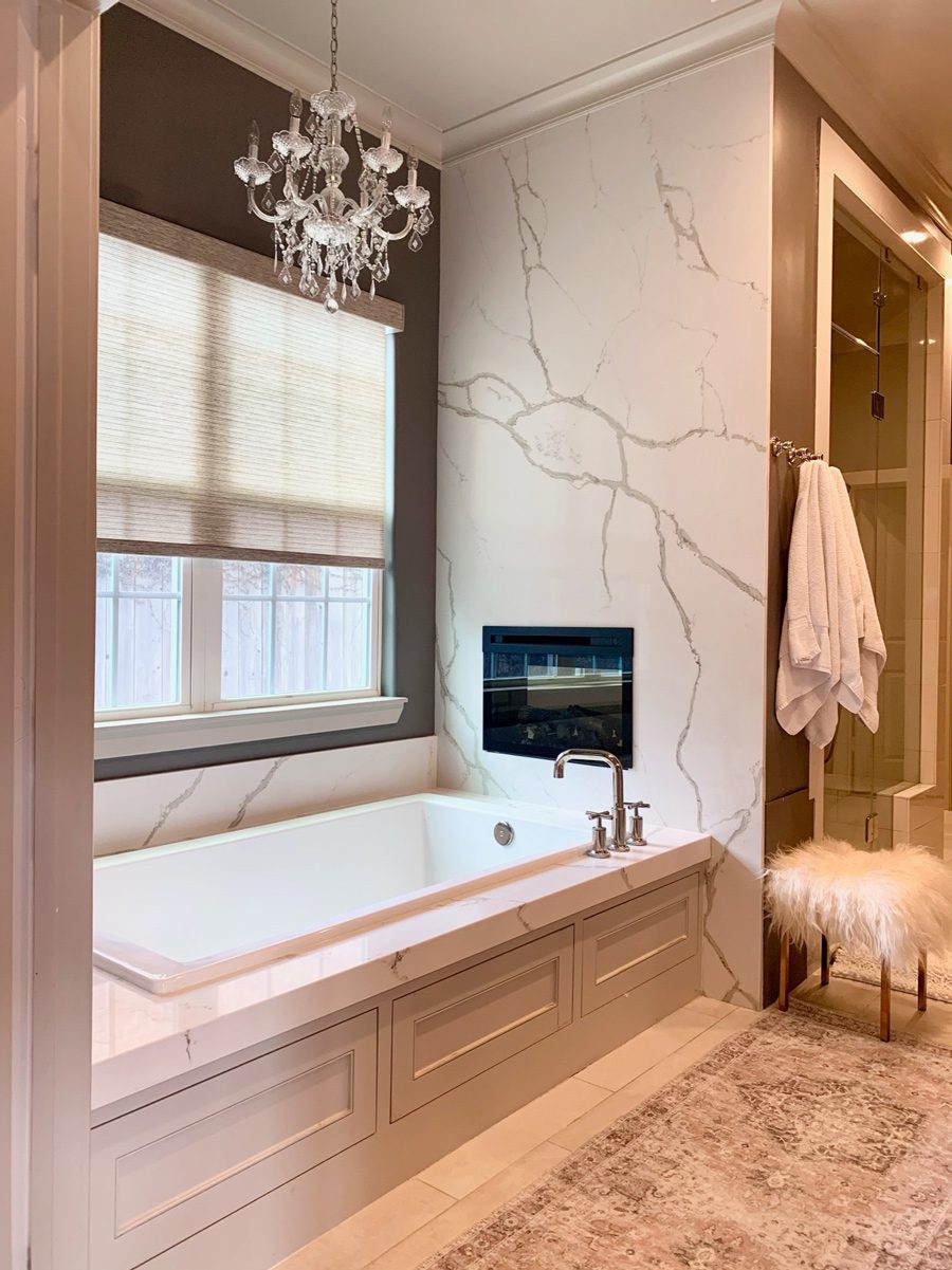 woven shades over master bathroom tub in Houston home