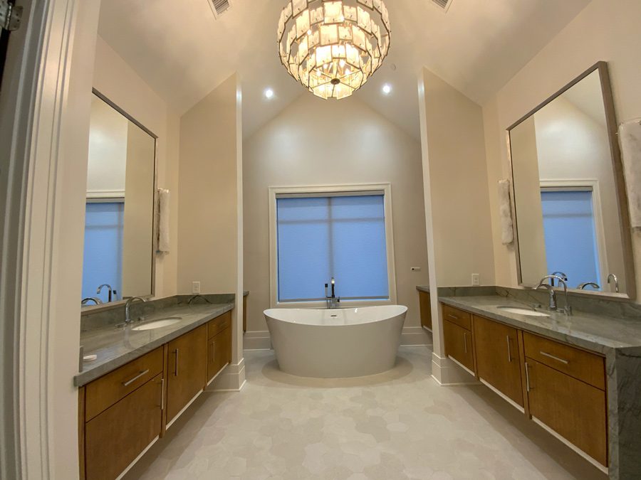 master bathroom with gray roller shades in West University TX