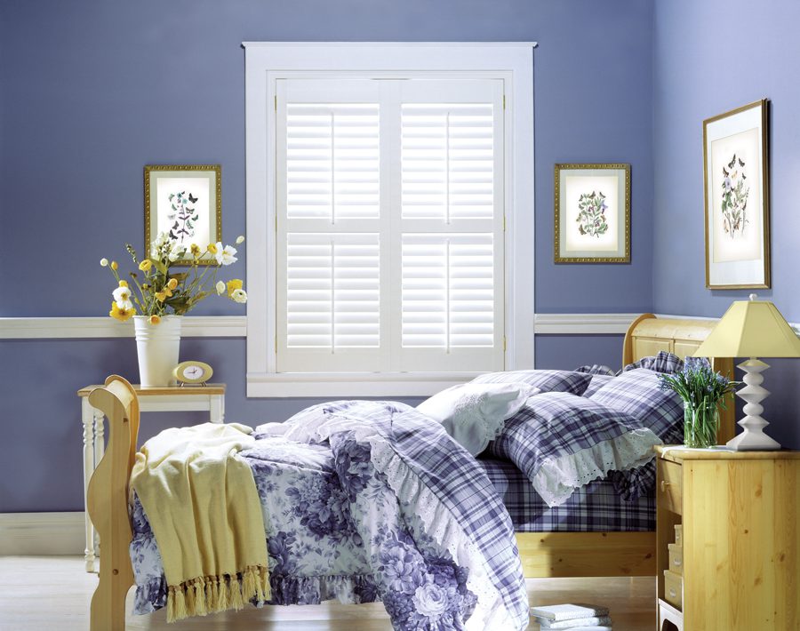 periwinkle bedroom with white shutters in Baybrook TX home