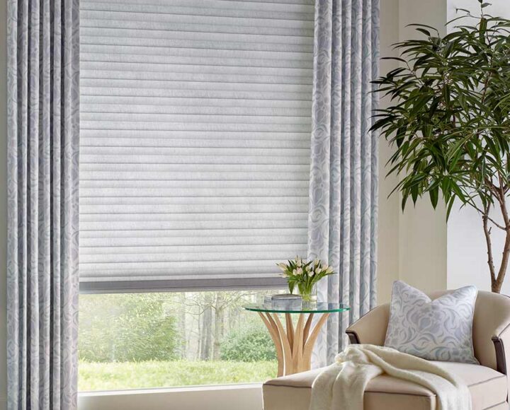soft gray curtains with gray honeycomb cellular shades for energy efficiency in traditional living room