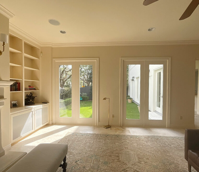 beige living room with two glass patio doors leading outside, houston, TX