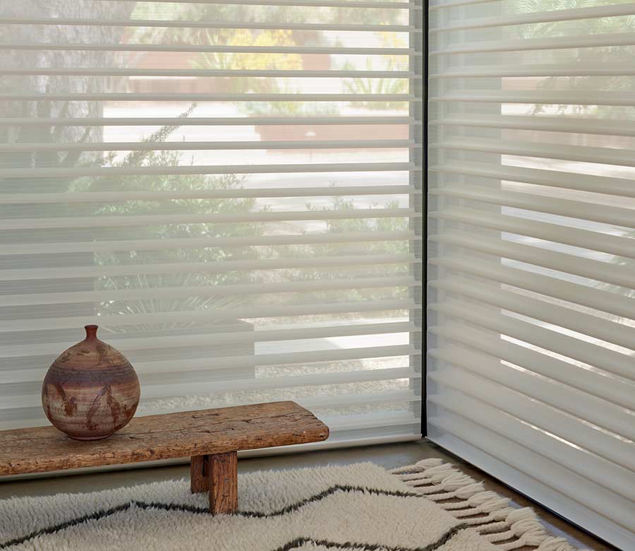 floor to ceiling light diffusing window shades with small bench and pottery