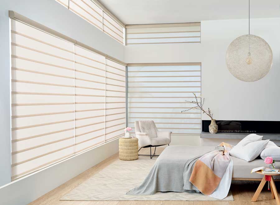 rolling roman shades in neutral bedroom