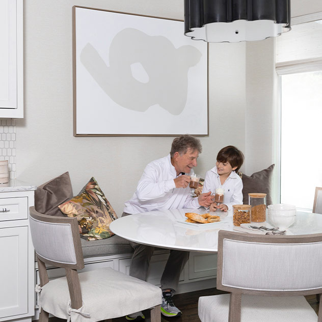 little boy and older man at dining room table in houston, TX