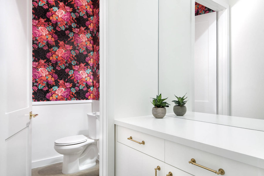 white powder room with hot pink and black floral wallpaper