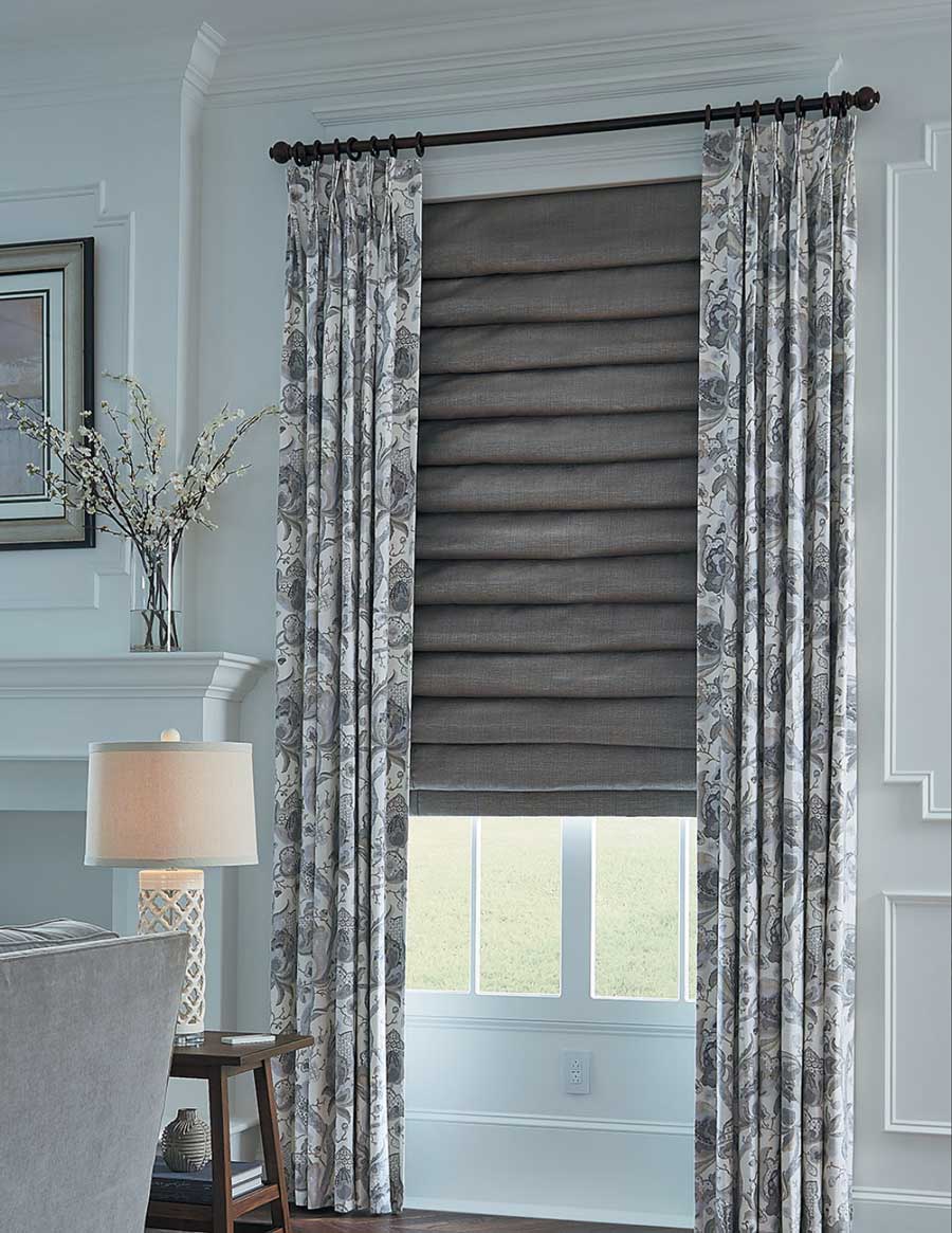 layered fabrics at the window in Houston home with custom draperies and roman shades