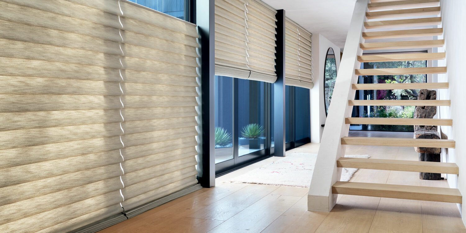 home office with tall windows covered with luminette sheer shades by Creative Blinds