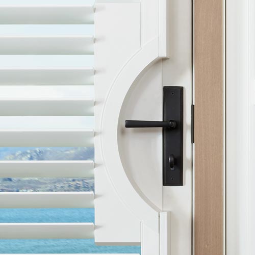 white shutters on door with door handle cutout