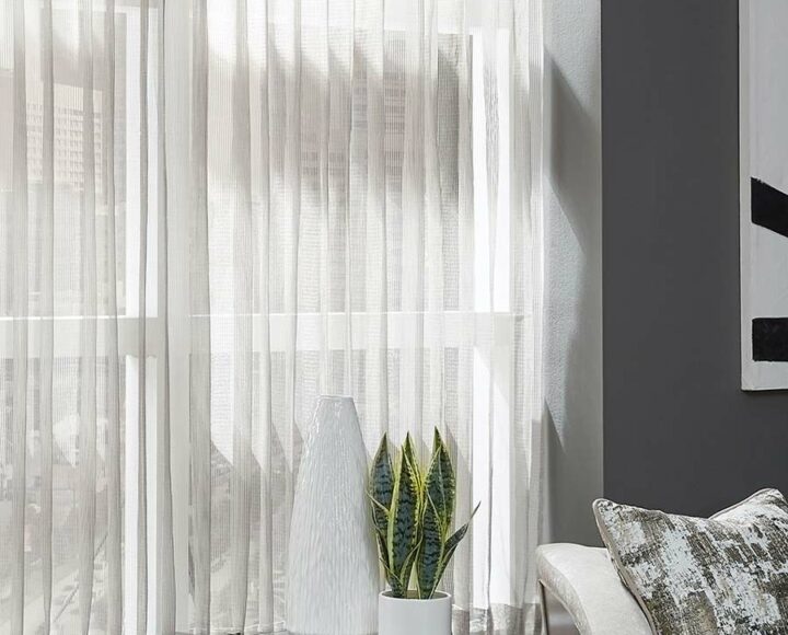 sheer curtains as custom window treatments with light coming through for modern living room in Houston