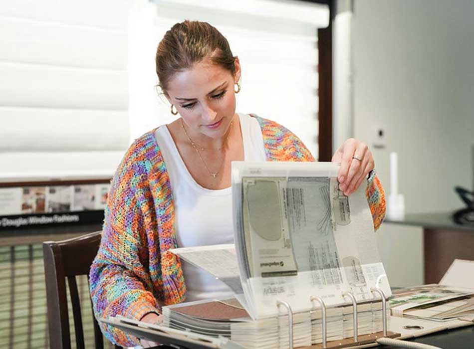 customer looking at color and fabric options in showroom baybrook creative blinds