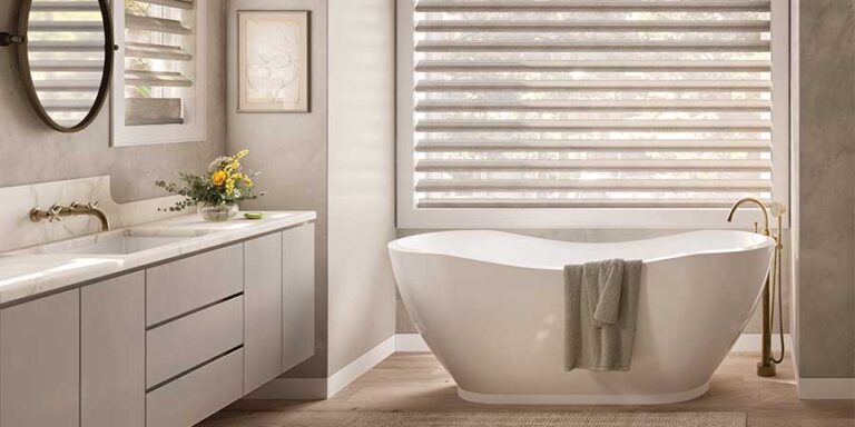 bathroom with white tub and cream shades above tub creative blinds