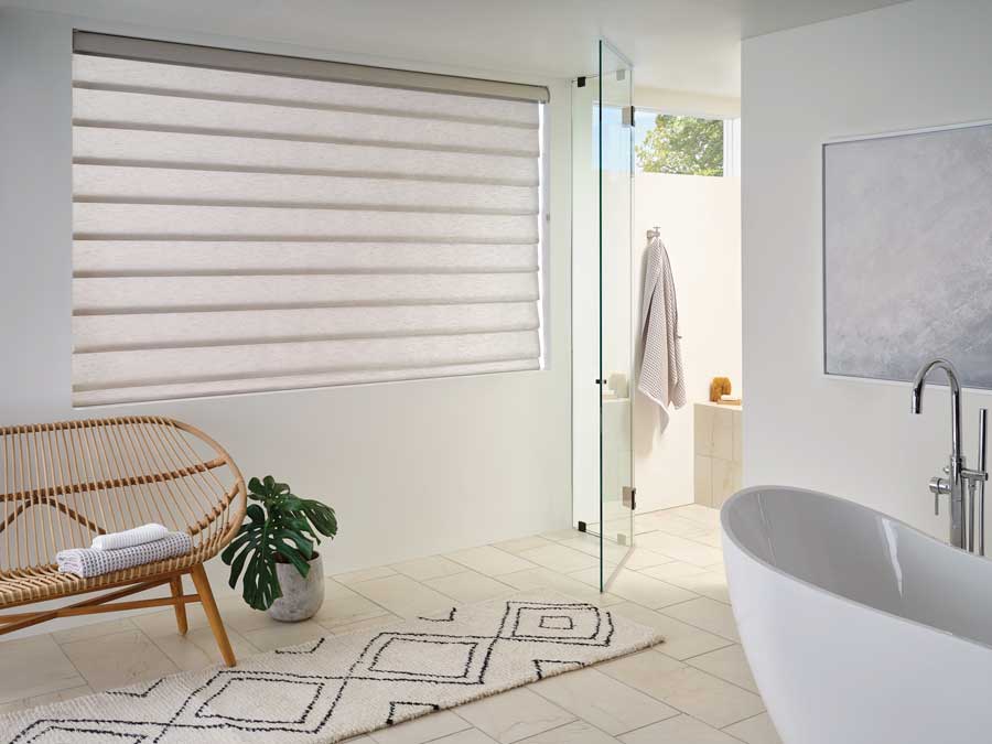 bathroom with vignette rolling roman shades in neutral tone