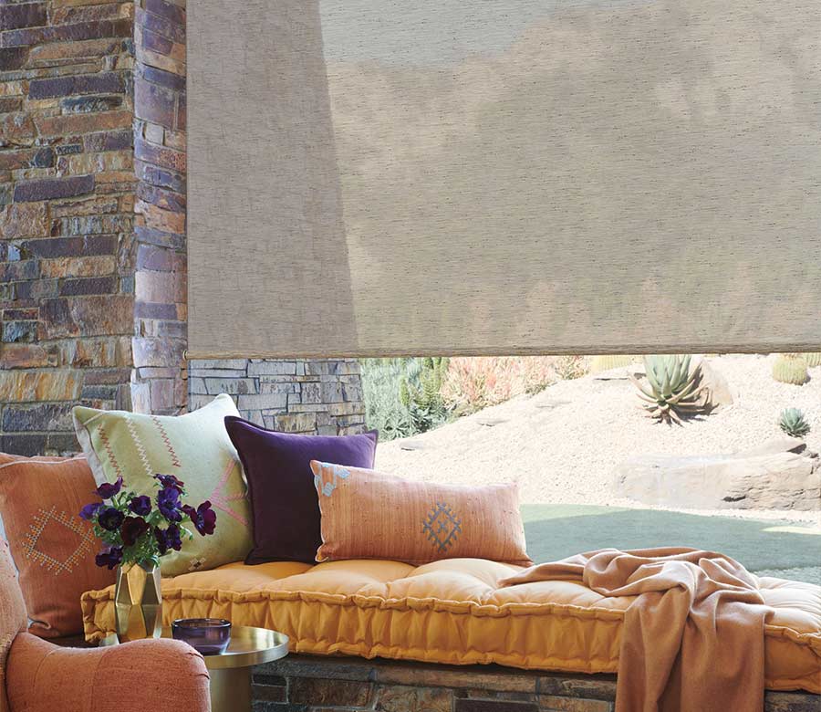 designer roller shades by window bench