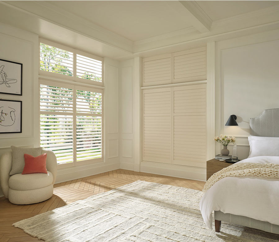 palm-beach-vinyl-automated-shutters-hunter-douglas-creative-blinds white vinyl shutters in bedroom