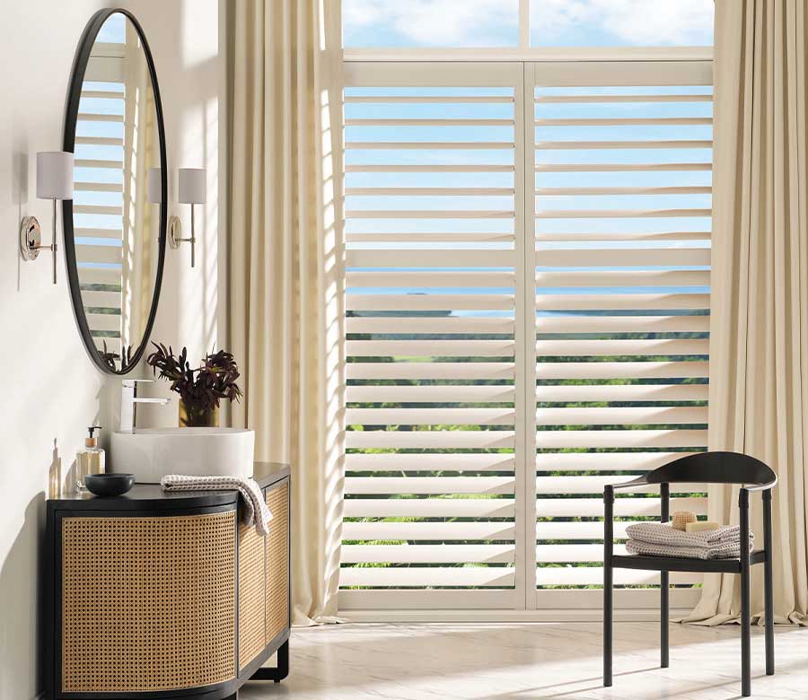 palm-beach-vinyl-bathroom-shutters-hunter-douglas-creative-blinds bedroom with palm beach vinyl shutters paired with custom drapery