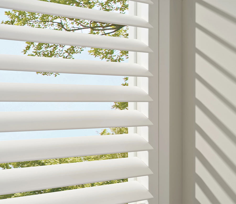 palm-beach-vinyl-shutters-moisture-resistant-shutters-hunter-douglas-creative-blinds close up of white vinyl shutters on window