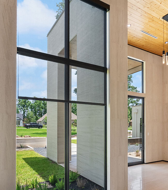 Black solar shades on hallway windows in a Galveston home