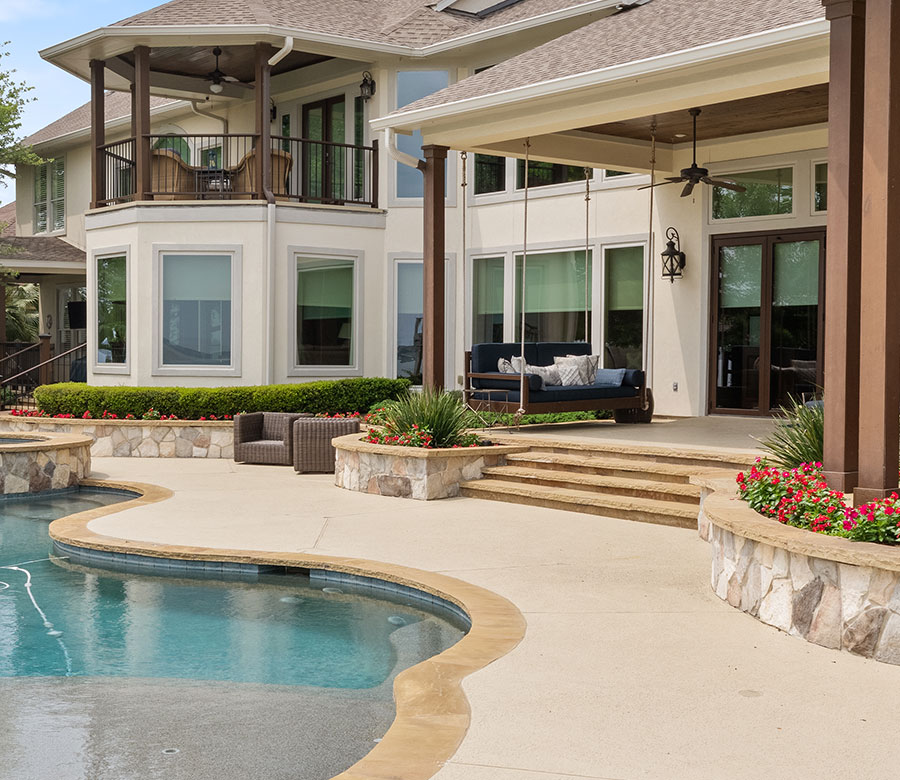 Exterior view of Lake Conroe home with Hunter Douglas Designer Roller Shades