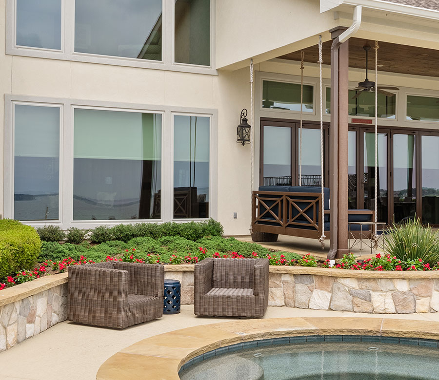 Lake Conroe home exterior with light-filtering roller shades in the windows