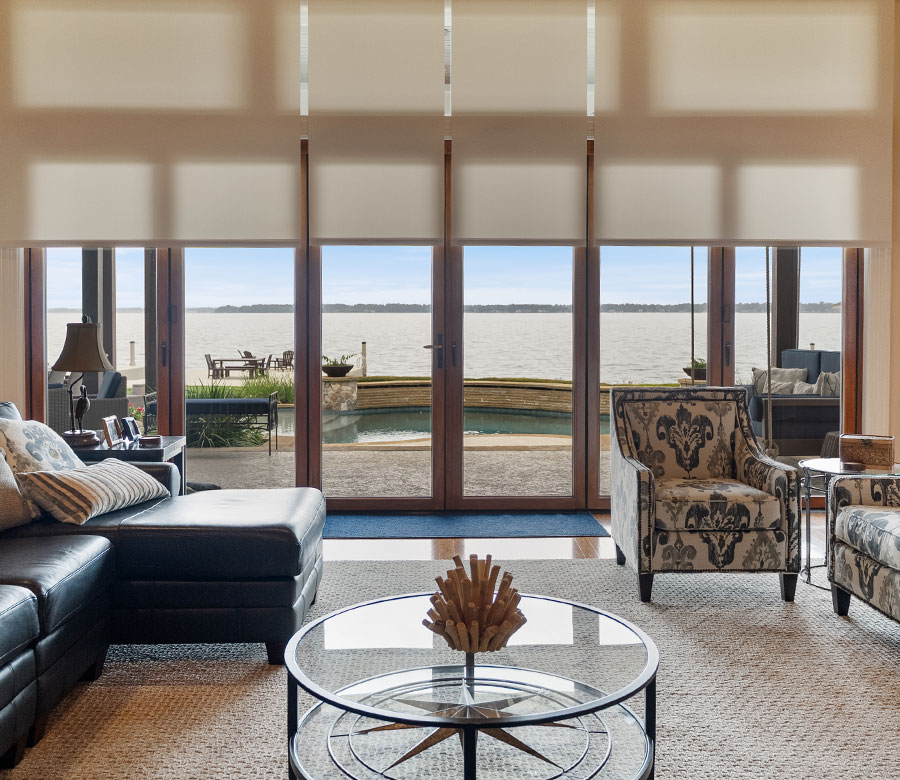 Light-filtering Designer Roller Shades framing Lake Conroe views