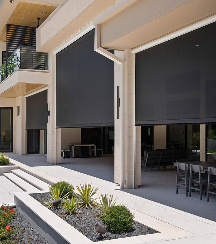 Motorized exterior shades across a large covered outdoor living area