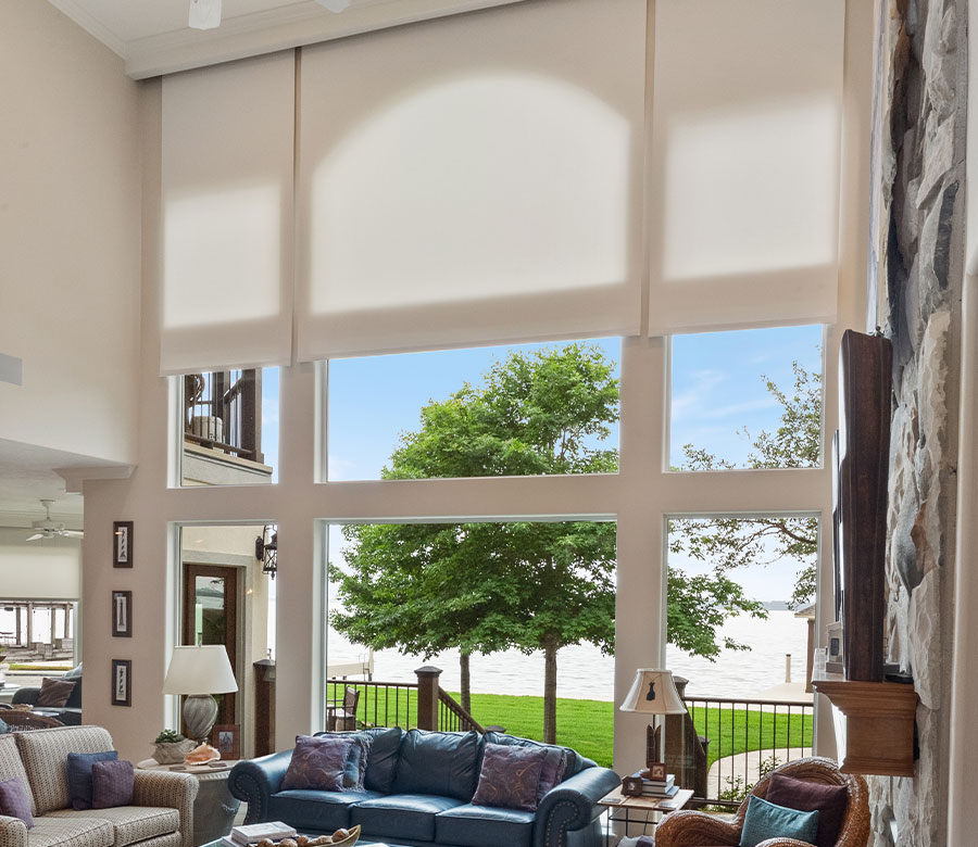 Light-filtering Designer Roller Shades framing Lake Conroe views